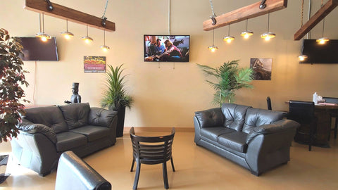 Infinity Forge event and meeting space with leather seating, display screens and wood beam lighting